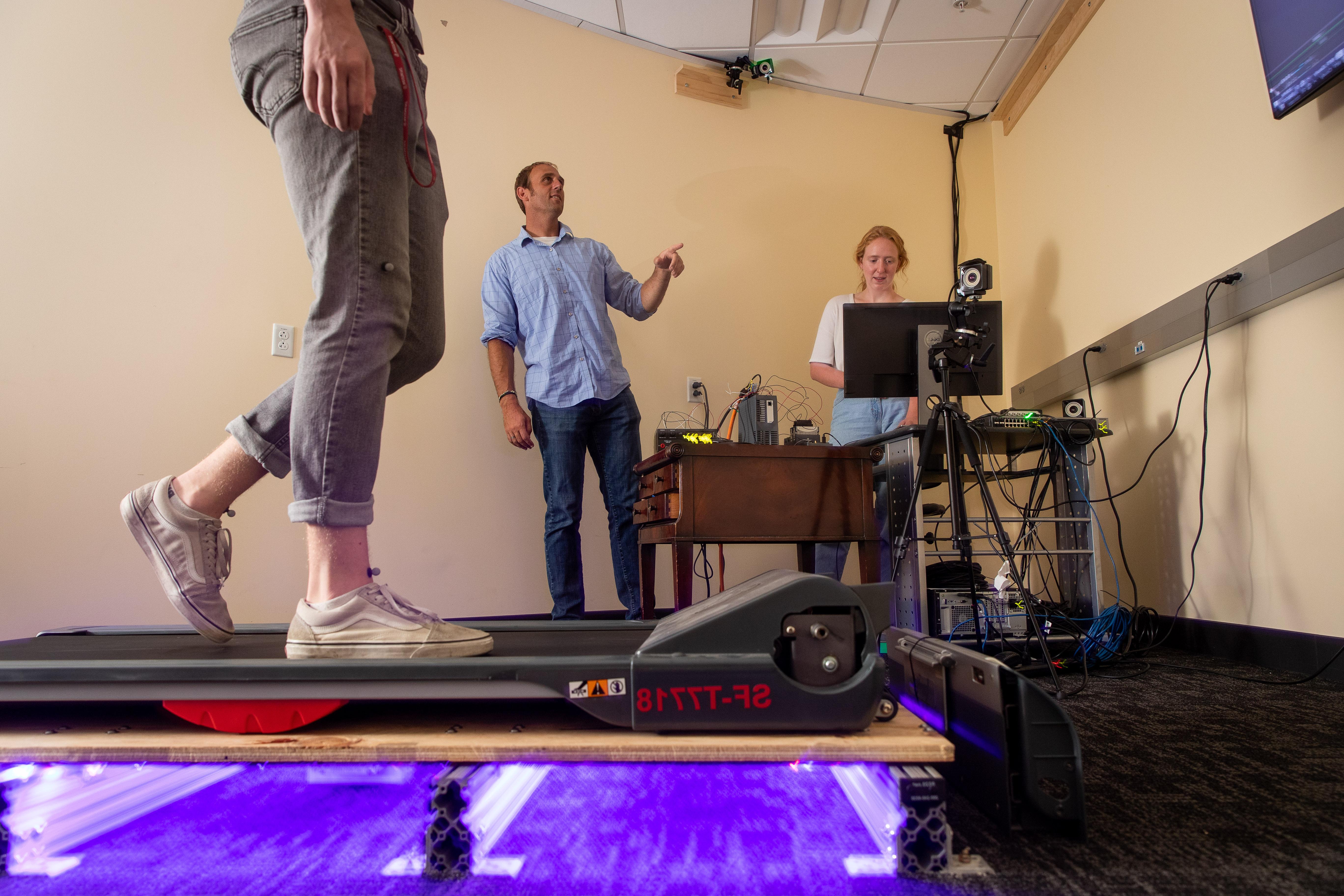 Adam Goodworth and student researchers on a treadmill